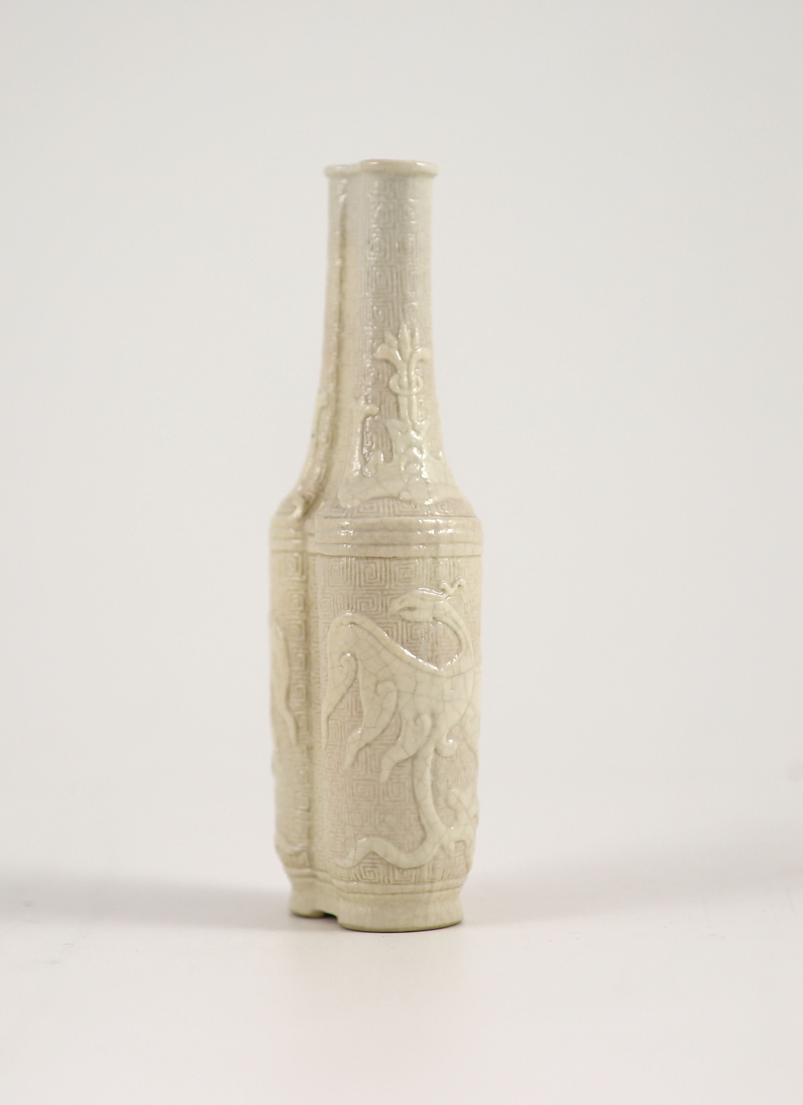 A small Chinese moulded and slip-decorated porcelain double-sided vase, Qianlong mark and period (1736-95), 14 cm high